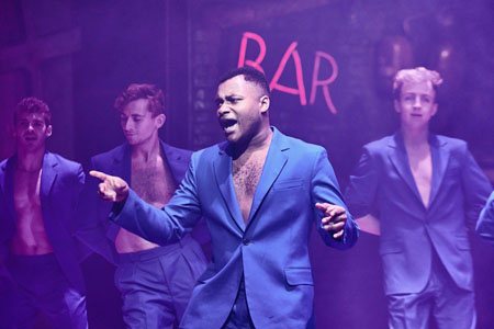 Jagwire (Dom Hartley-Harris) and various members of The Lost, wearing dapper blue suits