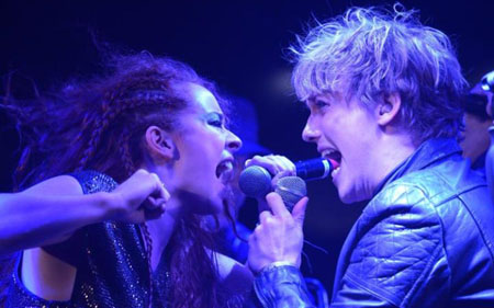 Georgia Carling and Andrew Polec, intensely singing