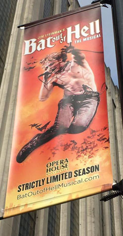 advertisement street banner for Bat Out Of Hell The Musical on a street in Manchester. There is a large photo of Strat (Andrew Polec) centre, the show logo at the top, and at the bottom - OPERA HOUSE, STRICTLY LIMITED SEASON batoutofhellmusical.com