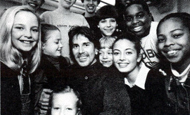 Davis Gaines surrounded by the children in the cast of the 1996 production of Whistle Down The Wind