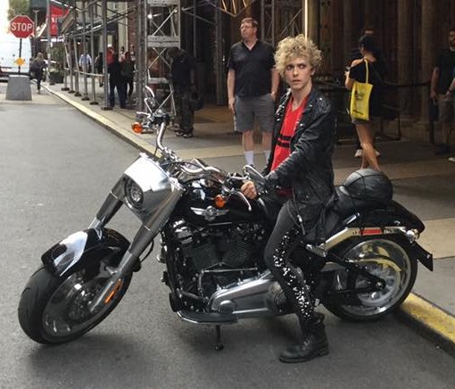 Andrew Polec sitting on a Harley Davidson